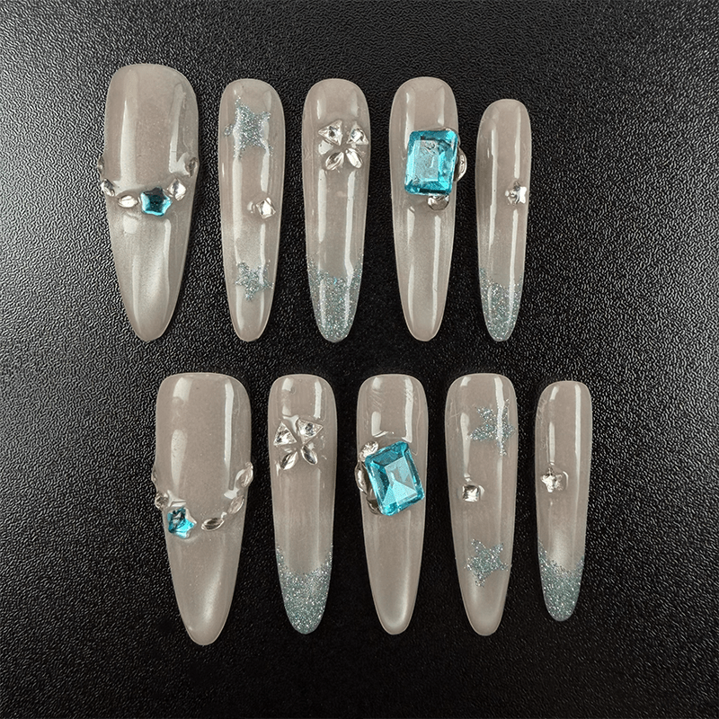 51 - Noah-UlightBlue glitter oval nails with aqua rhinestones and star-shaped gems