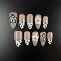 Almond cow print press-on nails with nude French tips