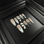 Black and nude press-on nails with 3D flowers and metal studs