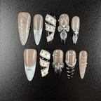 Black and nude almond press-on nails with silver chain details