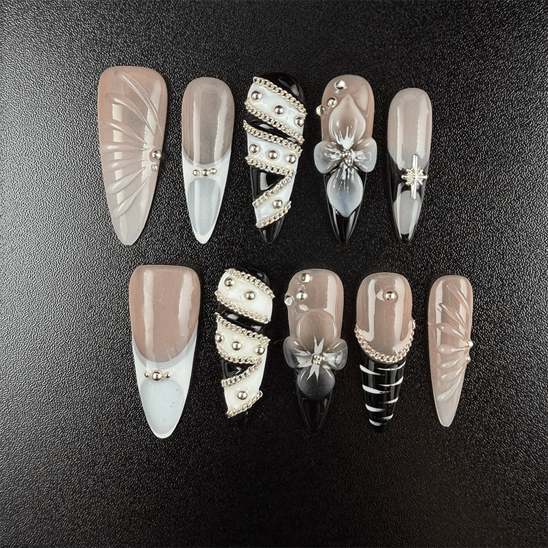 Black and nude almond press-on nails with silver chain details