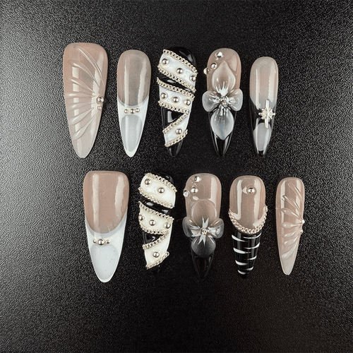 Black and nude almond press-on nails with silver chain details