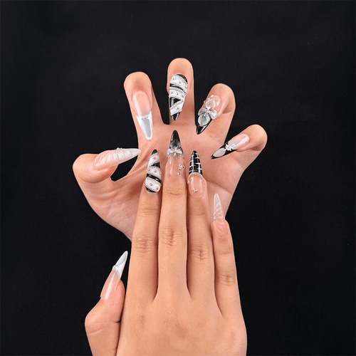 Black and nude almond press-on nails on hand