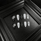 Black and white almond nails with lace and treble clef details