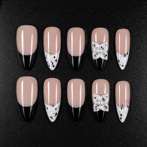 Black and white French tip press-on nails with a 3D pearl bow