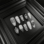 Gothic press-on nails with silver glitter lines and chrome crosses