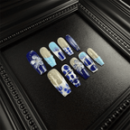 Hand-painted 3D floral details on blue and white press-on nails