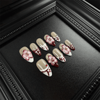 Burgundy and white French tip almond nails with red rhinestone accents