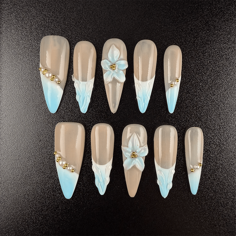 Long stiletto French tip press on nails with 3D blue flowers