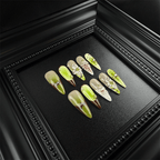 Extra long matcha green stiletto nails with marble and pearl details