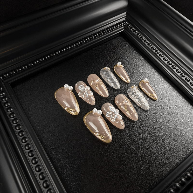 Nude almond nails with silver glitter and gold accents