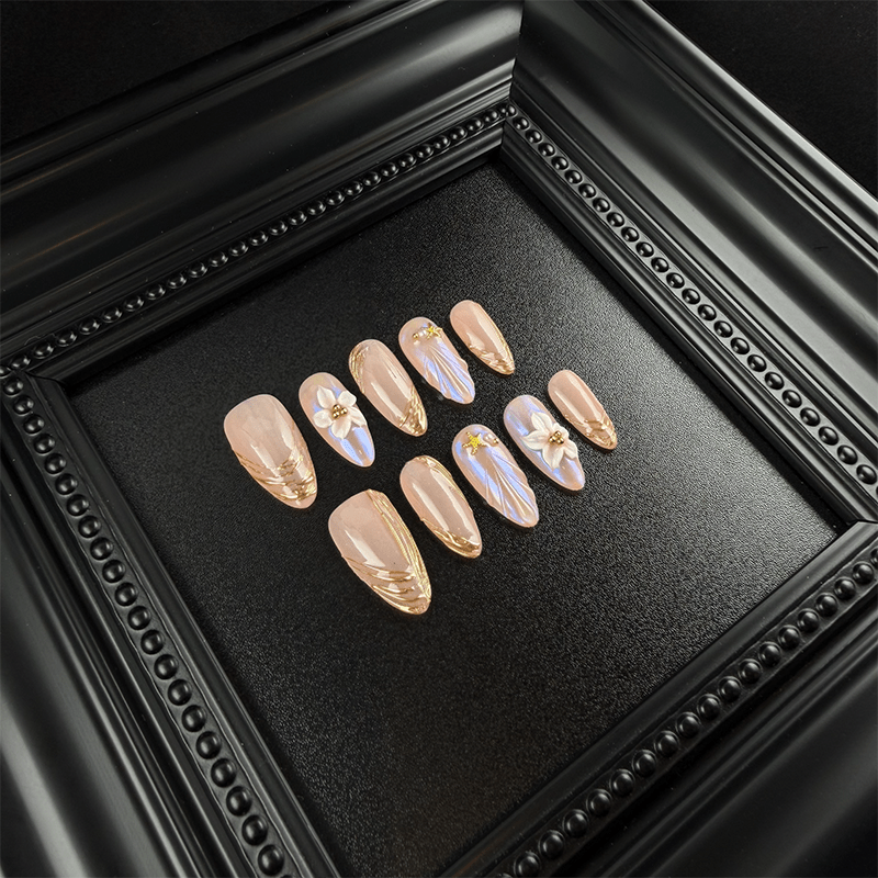 Long almond nude chrome press-on nails with 3D floral details