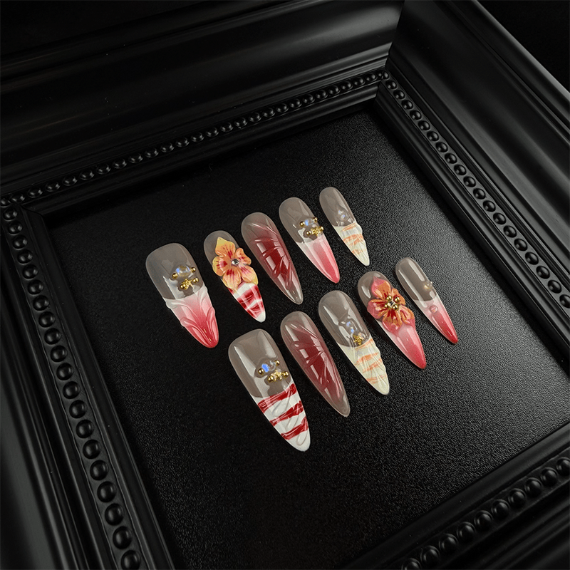 Long almond press-on nails with pink red gradient and marble details