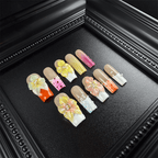 Pink and orange French tip press on nails with glossy pearl decorations